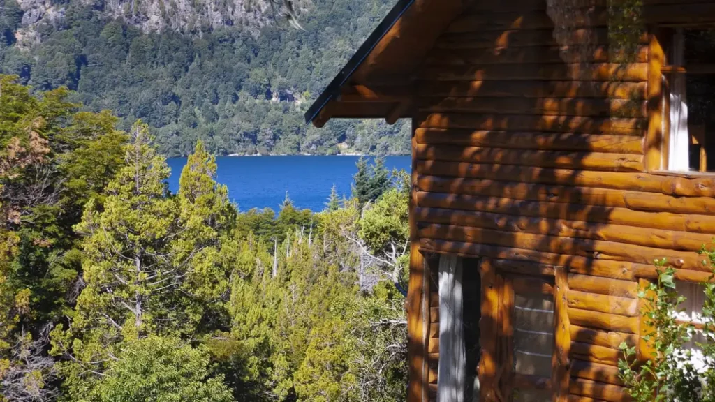 Chalé com bosque a rio ao fundo em Bariloche