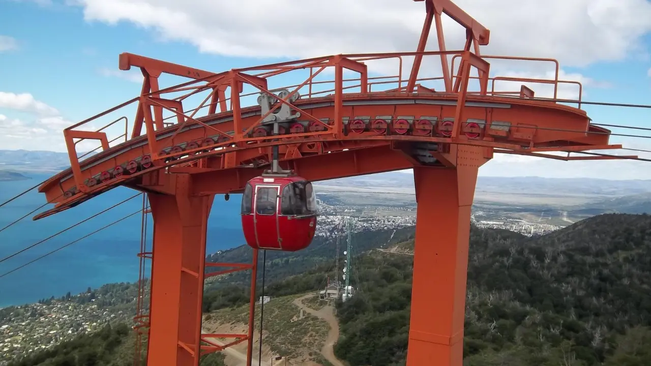 Teleférico Cerro Otto em Bariloche, Argentina, com vista panorâmica do lago Nahuel Huapi e das montanhas ao fundo.